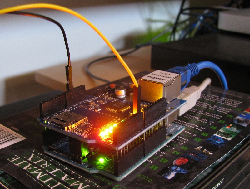 The stacked Arduino and Ethernet shield, on an insulating box.